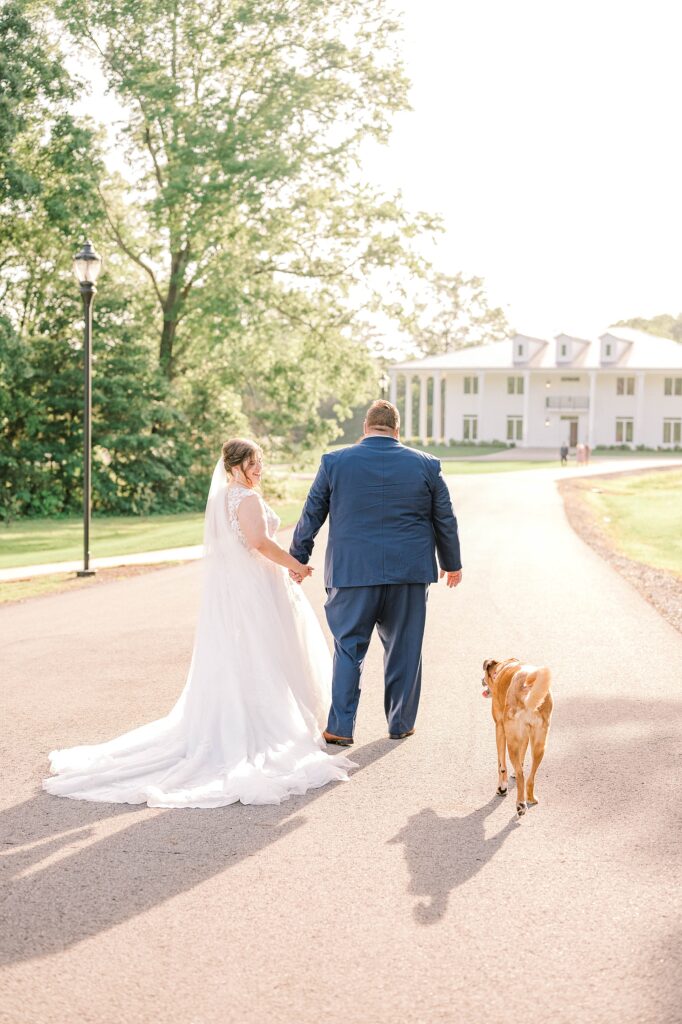 Bride & Groom portraits walking to the reception with their dog
